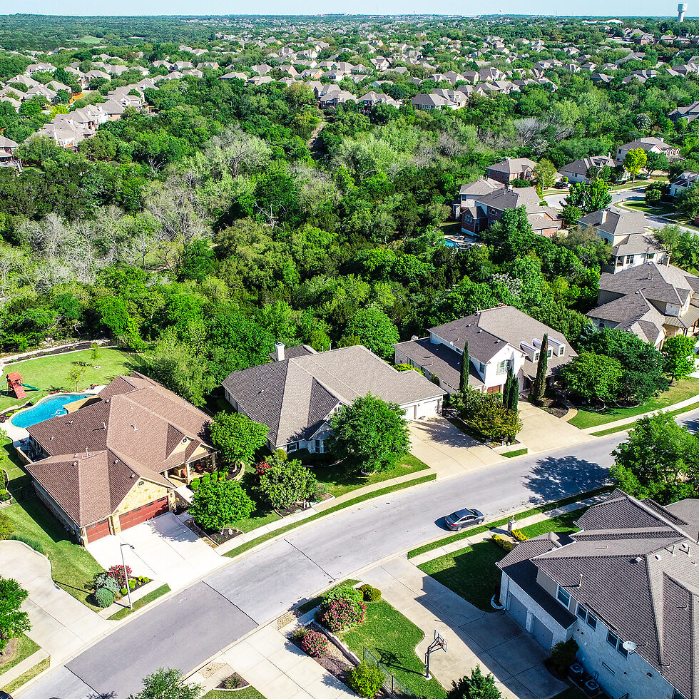 suburb neighborhood Cedar Park , Texas aerial drone view above Texas Hill Country Homes on a curved road leading into the Austin booming housing market real estate homes and houses from above green landscape